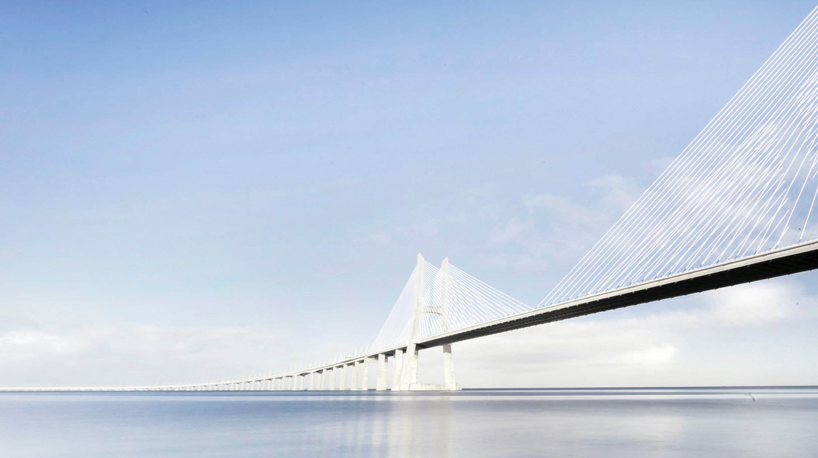 Vasco da Gama Bridge and Tagus river, sea, water, sky, sun reflection in Lisbon, Portugal